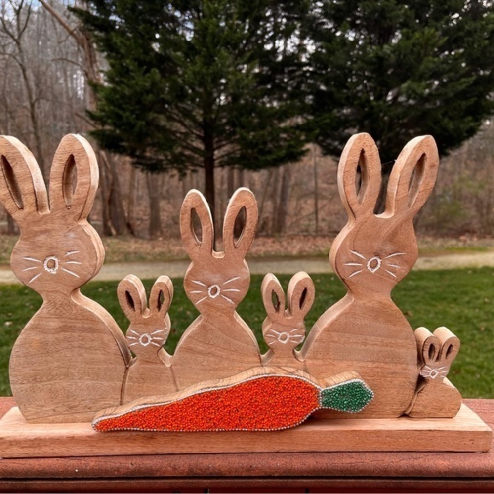 Wooden carved bunny family. Easter bunny rabbit family with carrot